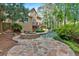 Expansive backyard features a swimming pool, stone hot tub, and deck of a beautiful home surrounded by trees at 4012 Ironhill Ln, Woodstock, GA 30189