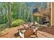 Inviting backyard patio featuring a fire pit, seating, and a covered outdoor living area, perfect for relaxation at 4012 Ironhill Ln, Woodstock, GA 30189