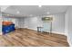 Large finished basement featuring wood-look floors and a neutral color scheme at 4012 Ironhill Ln, Woodstock, GA 30189
