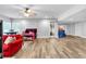 Bright finished basement with wood-look floors and multiple seating areas at 4012 Ironhill Ln, Woodstock, GA 30189
