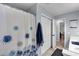 Bathroom with shower/tub combination with a blue floral shower curtain and a door to a walk-in closet at 4012 Ironhill Ln, Woodstock, GA 30189