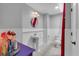 Charming bathroom with beadboard walls, a pedestal sink, and a toilet at 4012 Ironhill Ln, Woodstock, GA 30189