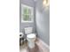 Bright bathroom featuring a new toilet and neutral wall color, illuminated by a natural light from window at 4012 Ironhill Ln, Woodstock, GA 30189