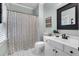 Bright bathroom with a shower-tub combination, white vanity, and stylish decor at 4012 Ironhill Ln, Woodstock, GA 30189