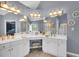 This bathroom boasts double sinks, vanity seating, mirrors, and updated lighting for a luxurious, spa-like experience at 4012 Ironhill Ln, Woodstock, GA 30189
