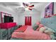 Charming bedroom with unique decor, plush bedding, ceiling fan, and television for a relaxing space at 4012 Ironhill Ln, Woodstock, GA 30189