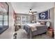 Bedroom with neutral walls, gray carpet and a queen-size bed near a wall-mounted desk and window at 4012 Ironhill Ln, Woodstock, GA 30189