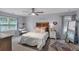 Bedroom featuring neutral paint, carpet, and a queen-size bed, with a dressing table near a bright window at 4012 Ironhill Ln, Woodstock, GA 30189