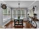 Bright dining area featuring hardwood floors, large windows, and a decorative bike-themed console table at 4012 Ironhill Ln, Woodstock, GA 30189