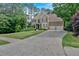 Beautiful traditional home with lush landscaping, a spacious driveway, and a two-car attached garage at 4012 Ironhill Ln, Woodstock, GA 30189