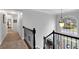 Foyer with staircase featuring a wrought iron banister and a large window for natural light at 4012 Ironhill Ln, Woodstock, GA 30189