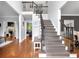 Elegant foyer with hardwood floors, staircase with iron railings, and open view to the living spaces at 4012 Ironhill Ln, Woodstock, GA 30189