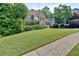 Charming brick home with lush landscaping and a well-manicured front lawn at 4012 Ironhill Ln, Woodstock, GA 30189