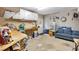 Spacious garage area including a punching bag, sofa, dart board, work bench, and overhead storage for an enthusiast at 4012 Ironhill Ln, Woodstock, GA 30189