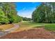 Scenic view of a well-maintained golf course surrounded by mature trees, providing a serene backdrop at 4012 Ironhill Ln, Woodstock, GA 30189