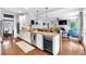 Open kitchen features granite countertops, stainless steel appliances, and breakfast bar at 4012 Ironhill Ln, Woodstock, GA 30189