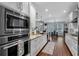 Well-equipped kitchen with stainless steel appliances and view to dining and living spaces at 4012 Ironhill Ln, Woodstock, GA 30189