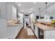 Open kitchen with white cabinetry, granite countertops, stainless appliances, and breakfast bar at 4012 Ironhill Ln, Woodstock, GA 30189