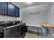 Laundry room featuring front load washer and dryer and folding table at 4012 Ironhill Ln, Woodstock, GA 30189