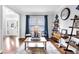 Cozy living room with hardwood floors, modern decor, and a view to the front entry at 4012 Ironhill Ln, Woodstock, GA 30189