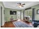 Cozy living room with green walls, wood floors, ceiling fan, and view to outdoor deck at 4012 Ironhill Ln, Woodstock, GA 30189