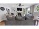 Comfortable living room featuring a stone fireplace, ceiling fan, and neutral color palette at 4012 Ironhill Ln, Woodstock, GA 30189
