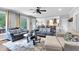 Open-concept living room with large windows and access to outdoor space and partial view of kitchen at 4012 Ironhill Ln, Woodstock, GA 30189
