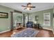 Living room with hardwood floors, ceiling fan, and large windows at 4012 Ironhill Ln, Woodstock, GA 30189
