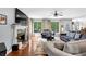 Comfortable living room with fireplace, large windows with backyard views, and stylish furniture at 4012 Ironhill Ln, Woodstock, GA 30189