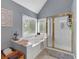 Main bathroom featuring a soaking tub and walk-in shower at 4012 Ironhill Ln, Woodstock, GA 30189
