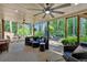 Covered patio with ample seating, ceiling fans, and view of the private wooded backyard at 4012 Ironhill Ln, Woodstock, GA 30189