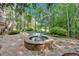 Gorgeous swimming pool and hot tub surrounded by a stone patio and lush greenery, backing onto a forest at 4012 Ironhill Ln, Woodstock, GA 30189