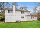 Backyard view of a home with well-maintained lawn and a large white exterior at 592 Cricket Hill Trl, Lawrenceville, GA 30044