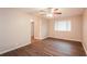 Spacious bedroom featuring wood-look floors, a ceiling fan, and a large window at 592 Cricket Hill Trl, Lawrenceville, GA 30044
