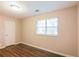 Bright bedroom featuring modern flooring, neutral walls, and ample natural light from a window at 592 Cricket Hill Trl, Lawrenceville, GA 30044