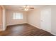 Bedroom with hardwood floors, ceiling fan, and a window allowing for natural light at 592 Cricket Hill Trl, Lawrenceville, GA 30044