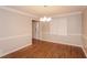 Dining room features wood-look floors, decorative molding, and contemporary chandelier at 592 Cricket Hill Trl, Lawrenceville, GA 30044