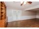 Living room featuring stylish flooring, built-in shelving, and access to the backyard at 592 Cricket Hill Trl, Lawrenceville, GA 30044