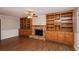 Cozy living room featuring a brick fireplace and custom-built wooden bookshelves at 592 Cricket Hill Trl, Lawrenceville, GA 30044