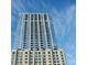 Exterior of high rise condo building with repeating balconies against a blue sky background at 855 Peachtree Ne St # 1311, Atlanta, GA 30308