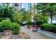 Enjoy lush landscaping and stone pathways in this high-rise community's garden with trees and benches at 855 Peachtree Ne St # 1311, Atlanta, GA 30308