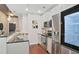 Contemporary kitchen boasts stainless steel appliances and sleek, white cabinetry at 855 Peachtree Ne St # 1311, Atlanta, GA 30308