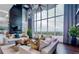 Bright and airy living room with large windows, hardwood floors, and stylish furnishings at 855 Peachtree Ne St # 1311, Atlanta, GA 30308