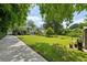 Expansive backyard showcasing a deck, stone patio, and lush lawn at 129 2Nd Se Ave, Atlanta, GA 30317