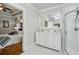 Bathroom with double vanity, glass shower, view into bedroom at 129 2Nd Se Ave, Atlanta, GA 30317