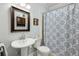 Traditional bathroom with pedestal sink and patterned shower curtain at 129 2Nd Se Ave, Atlanta, GA 30317