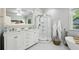 Bright bathroom features double vanity, glass enclosed shower, and soaker tub at 129 2Nd Se Ave, Atlanta, GA 30317
