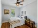 Cozy bedroom with hard wood floors, neutral paint, ceiling fan, and antique trunk at 129 2Nd Se Ave, Atlanta, GA 30317