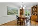 Spacious dining room featuring wood table, chairs, custom built-in cabinets and designer lighting at 129 2Nd Se Ave, Atlanta, GA 30317