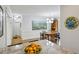 Open dining area featuring a stylish light fixture and view into the kitchen at 129 2Nd Se Ave, Atlanta, GA 30317